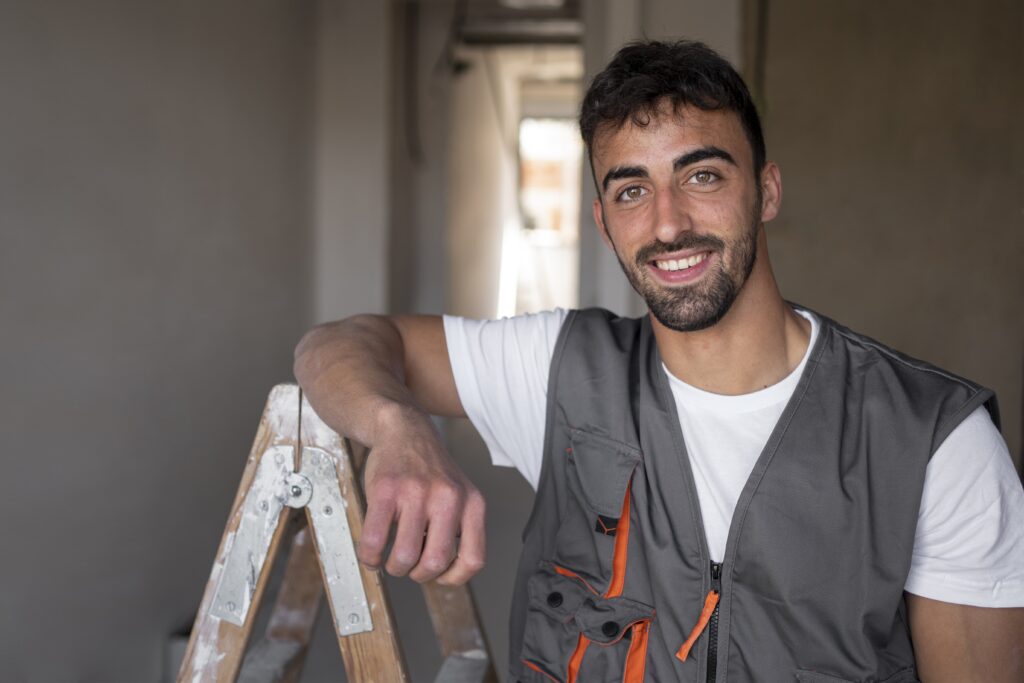 medium-shot-smiley-worker-wearing-vest-min